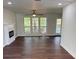 Bright living room featuring hardwood floors, a modern fireplace, and large windows at 311 Indus Ln, Lawrenceville, GA 30044