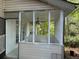 Cozy screened-in porch with ceiling fan, perfect for enjoying the outdoors in comfort at 311 Indus Ln, Lawrenceville, GA 30044