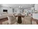 Dining area with seating for four, adjacent to the kitchen and living room in an open-concept space at 313 Foxglove Way, Mcdonough, GA 30253