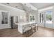 Modern kitchen with stainless appliances, island with seating, and direct access to the pool at 313 Foxglove Way, Mcdonough, GA 30253