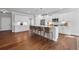 Spacious kitchen with white cabinets, stainless steel appliances, and a large island with seating at 313 Foxglove Way, Mcdonough, GA 30253