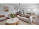 Comfortable living room with stylish decor, open to a modern kitchen and dining area at 313 Foxglove Way, Mcdonough, GA 30253