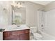 Bathroom with white fixtures, dark cabinets, and shower at 3328 Chastain Gardens Nw Dr, Kennesaw, GA 30144