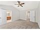 Bright bedroom boasts neutral walls, soft carpet, and access to a bathroom and hallway at 3328 Chastain Gardens Nw Dr, Kennesaw, GA 30144