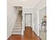 Bright foyer showcasing hardwood floors, staircase, and access to other rooms at 3328 Chastain Gardens Nw Dr, Kennesaw, GA 30144