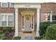 Inviting front entrance with classic door, decorative wreath, and white column supports at 3328 Chastain Gardens Nw Dr, Kennesaw, GA 30144