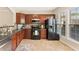 Well-lit kitchen with stainless steel appliances, tile floors, and plentiful cabinets at 3328 Chastain Gardens Nw Dr, Kennesaw, GA 30144