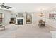 Open-concept living room featuring a fireplace, dining area, and natural light at 3328 Chastain Gardens Nw Dr, Kennesaw, GA 30144