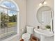 Bright powder room with pedestal sink and natural light from a large window at 3328 Chastain Gardens Nw Dr, Kennesaw, GA 30144