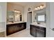 Bathroom featuring dual sinks and vanities with dark cabinets and tile floors at 5016 Garrett Ct, Alpharetta, GA 30005