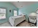 Bedroom offers a cozy space with aqua walls, natural light from the windows, and a small white desk at 5016 Garrett Ct, Alpharetta, GA 30005