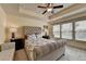 Comfortable bedroom featuring a ceiling fan, tray ceiling, and natural lighting at 5016 Garrett Ct, Alpharetta, GA 30005