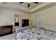 Comfortable bedroom featuring a ceiling fan, tray ceiling, and natural lighting at 5016 Garrett Ct, Alpharetta, GA 30005