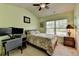 Well-lit bedroom with a desk, computer setup and large window with blind at 5016 Garrett Ct, Alpharetta, GA 30005
