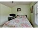 This cozy bedroom features a floral comforter, a computer desk setup, and light green painted walls at 5016 Garrett Ct, Alpharetta, GA 30005