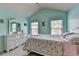 The bedroom features tranquil light blue walls, a dresser, and two windows creating a serene atmosphere at 5016 Garrett Ct, Alpharetta, GA 30005