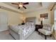 Comfortable bedroom featuring a ceiling fan, tray ceiling, and natural lighting at 5016 Garrett Ct, Alpharetta, GA 30005
