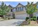 The townhome has a brick facade, a two-car garage, a concrete driveway, and a manicured front yard at 5016 Garrett Ct, Alpharetta, GA 30005