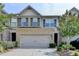 Inviting two-story home featuring a brick facade and a two-car garage at 5016 Garrett Ct, Alpharetta, GA 30005