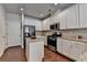 Modern kitchen featuring stainless steel appliances, granite countertops, and ample cabinet space at 5016 Garrett Ct, Alpharetta, GA 30005