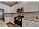 Modern kitchen with stainless steel appliances, granite countertops, and stylish backsplash at 5016 Garrett Ct, Alpharetta, GA 30005