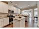 Open kitchen featuring stainless steel appliances, granite countertops, and seamless flow to dining area at 5016 Garrett Ct, Alpharetta, GA 30005