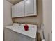 The laundry room offers modern convenience with a washer, dryer, and overhead white cabinets at 5016 Garrett Ct, Alpharetta, GA 30005