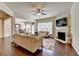 Bright living room featuring a fireplace, hardwood floors, and stylish sofas at 5016 Garrett Ct, Alpharetta, GA 30005
