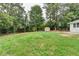 Expansive backyard featuring mature trees and a well maintained lawn at 1094 Amber Sw Rdg, Lilburn, GA 30047