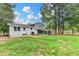Expansive backyard featuring a screened in porch, mature trees and a well maintained lawn at 1094 Amber Sw Rdg, Lilburn, GA 30047