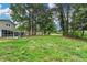 Spacious backyard with large trees, well-maintained lawn, and partial view of the home's screened-in porch at 1094 Amber Sw Rdg, Lilburn, GA 30047
