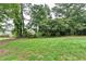 Lush backyard with well-maintained lawn and mature trees, backing up to wooded area for added privacy at 1094 Amber Sw Rdg, Lilburn, GA 30047