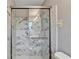 Bathroom featuring a glass shower with marble tile and a gray wall color at 1094 Amber Sw Rdg, Lilburn, GA 30047