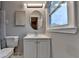 Bathroom featuring an oval mirror, sink with vanity, and a modern toilet at 1094 Amber Sw Rdg, Lilburn, GA 30047