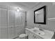 Updated bathroom with a modern vanity, a mirror, and a cabinet with white doors at 1094 Amber Sw Rdg, Lilburn, GA 30047