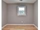 Cozy bedroom with grey walls, hardwood floors, and a window at 1094 Amber Sw Rdg, Lilburn, GA 30047