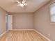 Bedroom featuring neutral walls, a ceiling fan, wood-look flooring, and natural light from a window at 1094 Amber Sw Rdg, Lilburn, GA 30047
