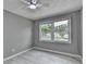 Cozy bedroom featuring light gray walls, wood-look flooring and natural light from double windows at 1094 Amber Sw Rdg, Lilburn, GA 30047