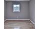 Cozy bedroom with grey walls, hardwood floors, and a window at 1094 Amber Sw Rdg, Lilburn, GA 30047