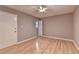Bedroom with neutral walls, wood-look flooring, a ceiling fan, and access to an ensuite bathroom at 1094 Amber Sw Rdg, Lilburn, GA 30047