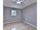 Bedroom with hardwood floors, ceiling fan, and a window bringing in natural light at 1094 Amber Sw Rdg, Lilburn, GA 30047