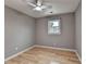 Neutral bedroom with hardwood floors, ceiling fan, and a window bringing in natural light at 1094 Amber Sw Rdg, Lilburn, GA 30047