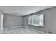 Bedroom featuring grey walls, wood flooring, ceiling fan, and a bay window providing lots of natural light at 1094 Amber Sw Rdg, Lilburn, GA 30047