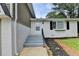 Inviting front entrance with gray painted steps and brickwork with a well maintained lawn at 1094 Amber Sw Rdg, Lilburn, GA 30047
