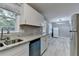 Kitchen featuring white cabinets, granite countertops, stainless steel appliances, and an open layout at 1094 Amber Sw Rdg, Lilburn, GA 30047