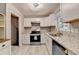 Kitchen featuring white cabinets, granite countertops, stainless steel appliances and modern lighting at 1094 Amber Sw Rdg, Lilburn, GA 30047