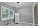 Kitchen area featuring modern lighting fixture, a refrigerator, and a window providing plenty of natural light at 1094 Amber Sw Rdg, Lilburn, GA 30047