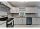 Bright kitchen featuring white cabinets, stainless steel appliances and granite countertops at 1094 Amber Sw Rdg, Lilburn, GA 30047