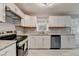 Kitchen featuring granite countertops, stainless steel appliances, white cabinets, and modern lighting at 1094 Amber Sw Rdg, Lilburn, GA 30047