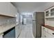 Modern kitchen with white cabinets, granite countertops, and stainless steel appliances at 1094 Amber Sw Rdg, Lilburn, GA 30047